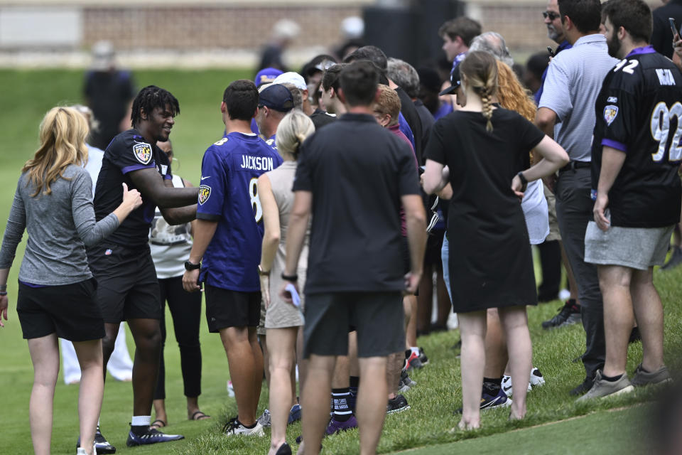 Baltimore Ravens quarterback Lamar Jackson greets spectators after taking part in drills at the NFL football team's practice facility, Thursday, June 16, 2022, in Owings Mills, Md. (AP Photo/Gail Burton)