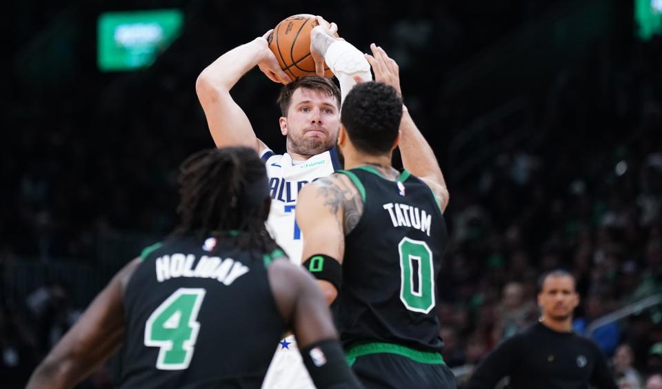 The Dallas Mavericks' Luka Doncic (77) looks to pass the ball during a game against the Boston Celtics at TD Garden on March 1, 2024.