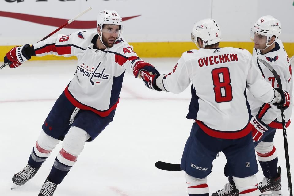 Washington Capitals' Tom Wilson (43) celebrates his goal with teammates Alex Ovechkin (8) and Conor Sheary (73) during the second period of an NHL hockey game against the Boston Bruins, Sunday, April 11, 2021, in Boston. (AP Photo/Michael Dwyer)