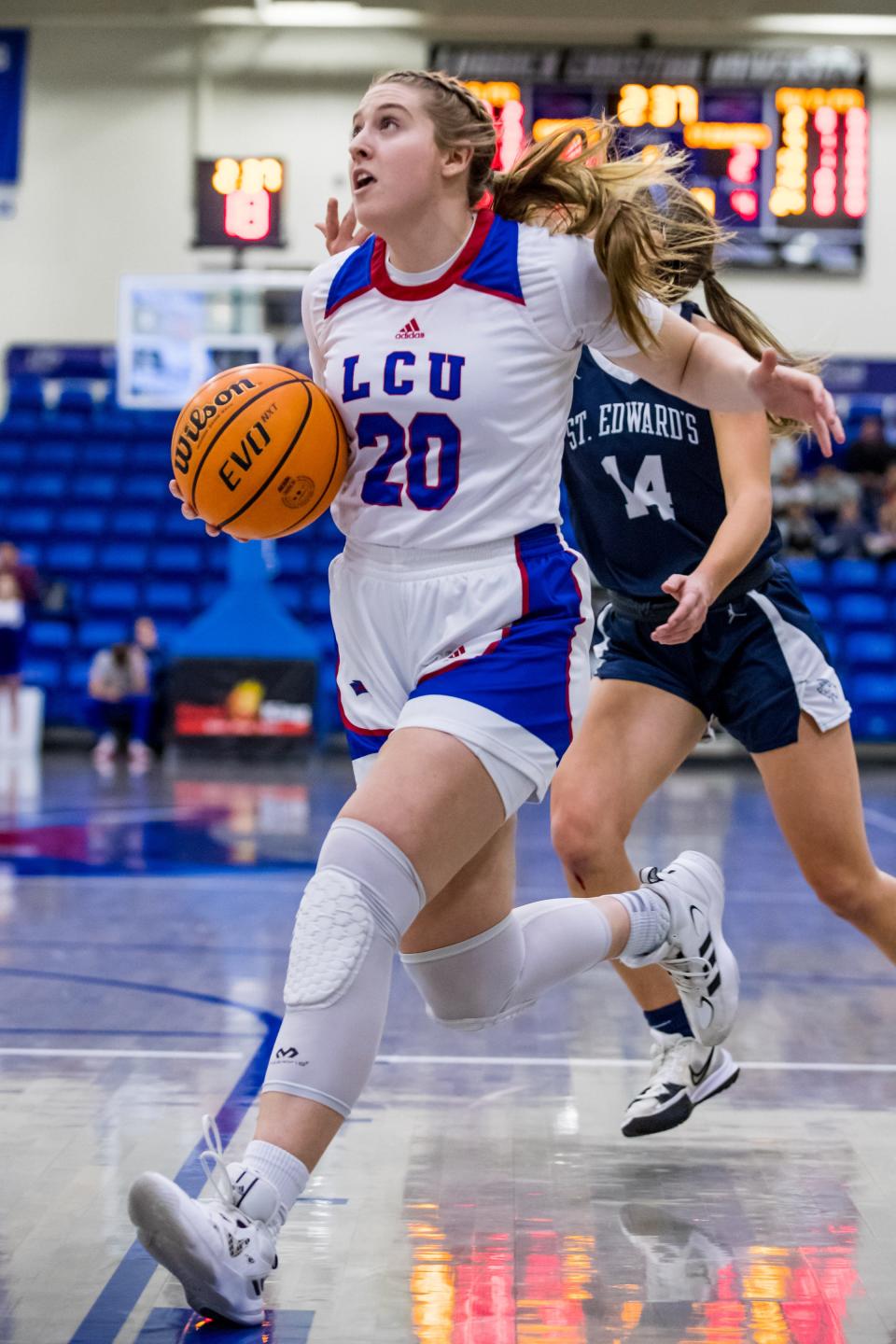 LCU's Carli Bostwick (20) drives to the basket during the Lady Chaps' 55-29 victory over St. Edward's on Thursday night at the Rip Griffin Center.