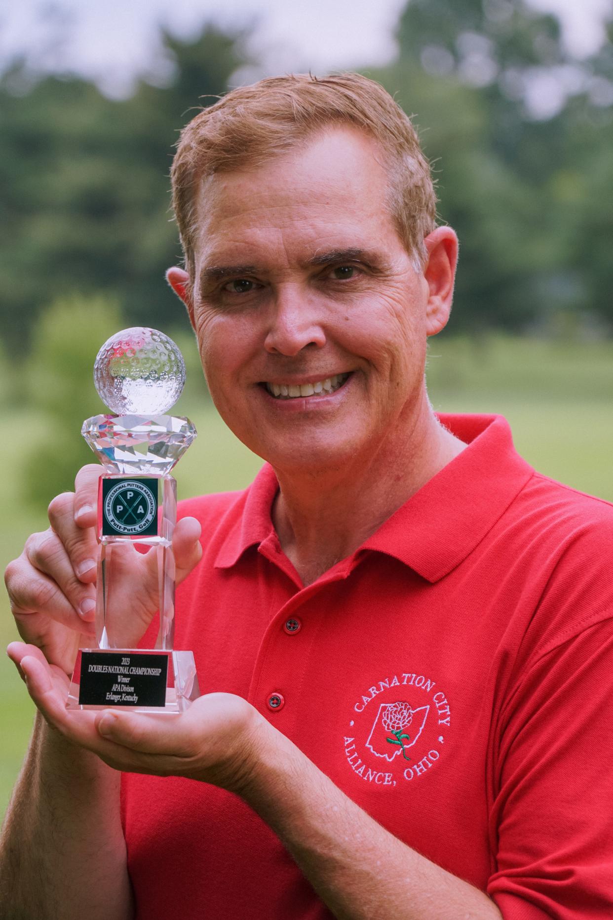 A graduate of Alliance High School in 1980, David Phillippi, 61, of Cincinnati holds a trophy he won at the 2023 Putt-Putt Golf National Championship in Kentucky from Aug. 7-11. He won the APA National Doubles Championship and finished fourth in individual championship play.