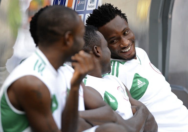 Midfielder John Obi Mikel (R) shares a joke with his Nigerian team-mates as they prepare for a training session at Soccer City in Soweto on February 9, 2013. Nigeria are strongly fancied to be crowned African football kings for a third time on Sunday by bringing the fairytale run of Burkina Faso to an end