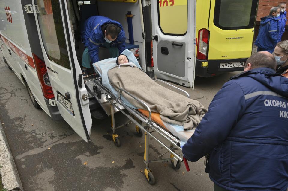 Medical staff carry an injured person on a stretcher at the emergency department of the First Republican Clinical hospital to evacuate to Moscow, in Izhevsk, Russia, Tuesday, Sept. 27, 2022. The plane of the Ministry of Emergency Situations will deliver victims of the shooting at school No. 88 in Izhevsk to Moscow hospitals. This was stated by the Presidential Commissioner for Children's Rights Maria Lvova-Belova. According to officials, 11 children were among those killed in the Monday morning shooting in School No. 88 in Izhevsk, a city 960 kilometers (600 miles) east of Moscow.(AP Photo/Dmitry Serebryakov)