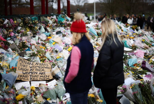 People observe a memorial site at the Clapham Common Bandstand, following the kidnapping and murder of Sarah Everard, in London, Britain, March 21, 2021. REUTERS/Henry Nicholls