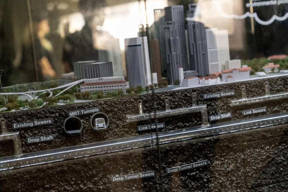 A model shows the underground deep tunnel sewer system as a youth group tours the NEWater visitor center in Singapore, Tuesday, July 18, 2023. A massive wastewater recycling program, which draws wastewater through tunnels linked to the island's sewers, purifies wastewater through microfiltration, reverse osmosis and ultraviolet radiation, adding to drinking supply reservoirs. (AP Photo/David Goldman)