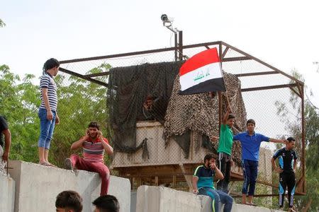 Followers of Iraq's Shi'ite cleric Moqtada al-Sadr storm Baghdad's Green Zone after lawmakers failed to convene for a vote on overhauling the government, in Iraq April 30, 2016. REUTERS/Khalid al Mousily