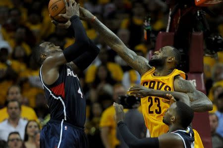 May 24, 2015; Cleveland, OH, USA; Cleveland Cavaliers forward LeBron James (23) blocks the shot of Atlanta Hawks forward Paul Millsap (4) during overtime in game three of the Eastern Conference Finals of the NBA Playoffs at Quicken Loans Arena. Mandatory Credit: Ken Blaze-USA TODAY Sports