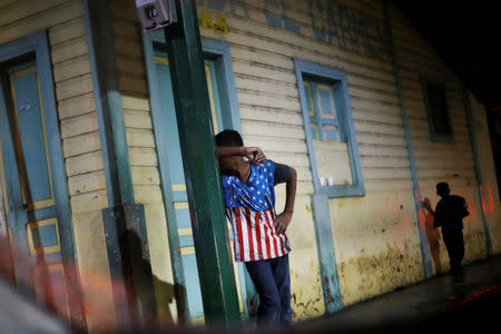 A Honduran migrant, part of a caravan trying to reach the U.S., gestures during a new leg of his travel in Tecun Uman, Guatemala October 18, 2018. REUTERS/Edgard Garrido