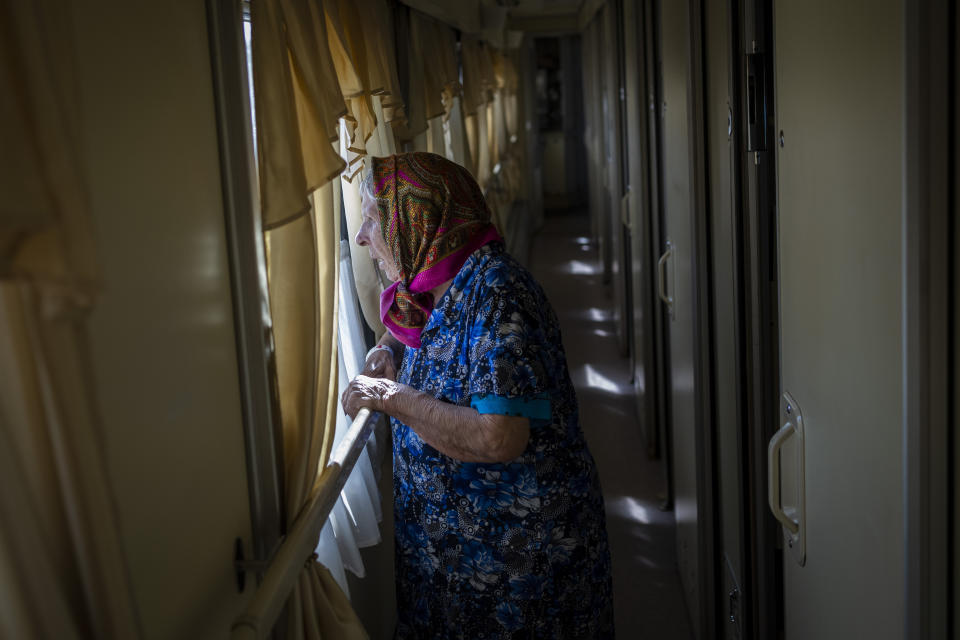 An elderly woman who has been evacuated from the Lysychansk area look out the window of an evacuation train in Pokrovsk in eastern Ukraine, Friday, June 10, 2022. (AP Photo/Bernat Armangue )