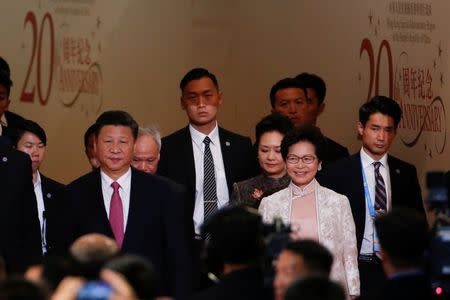 Hong Kong Chief Executive Carrie Lam and Chinese President Xi Jinping arrive for Lam's swearing in ceremony on the 20th anniversary of the city's handover from British to Chinese rule, in Hong Kong, China, July 1, 2017. REUTERS/Bobby Yip