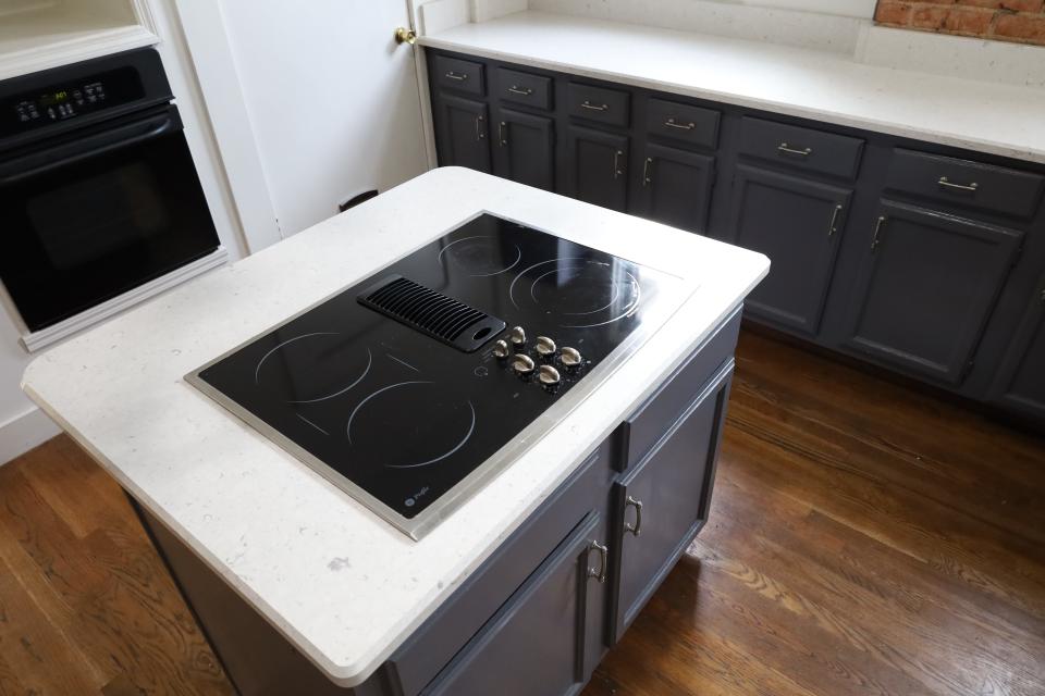 The new kitchen in the Central Gardens home features an island stove top, as well as an oven embedded into the wall.