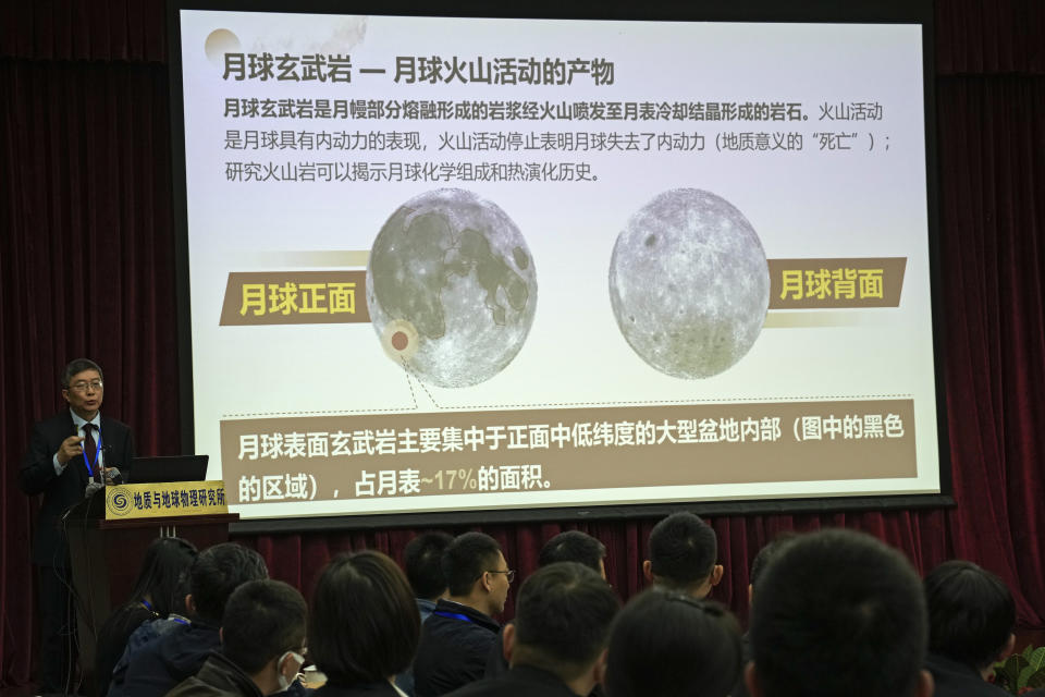 Li Xianhua speaks near a screen showing the volcano activities on the moon during a press briefing on Chang'e 5 Moon Mission, at the Chinese Academy Science in Beijing, Tuesday, Oct. 19, 2021. Moon rocks that a Chinese robotic space craft brought back to Earth last year have provided new insights into ancient lunar volcanic activity, a researcher said Tuesday. Li said an analysis of the samples revealed new information about the moon's chemical composition and the way heat affected its development. (AP Photo/Andy Wong)