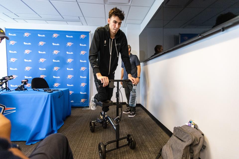 Thunder rookie Chet Holmgren leaves a news conference Thursday about his foot injury while using a scooter.