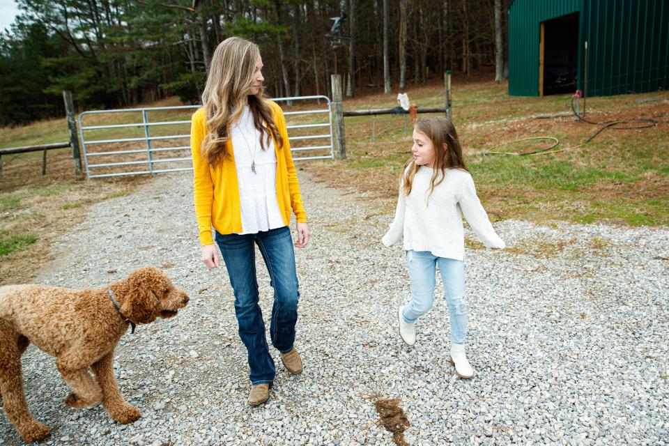 Megan Heichelbech walks with her daughter Makayla on their farm in Culleoka, Tenn. on Jan. 24, 2023.