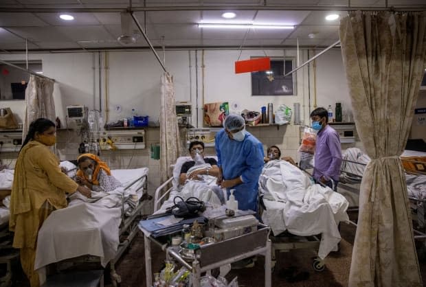 Medical staff work long hours with dwindling resources as COVID infections explode in India. People watching the news in Saskatchewan say they feel helpless. (Danish Siddiqui/Reuters - image credit)