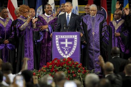 U.S. President Barack Obama leads mourners in singing the song "Amazing Grace" as he delivers a eulogy in honor of the Reverend Clementa Pinckney during funeral services for Pinckney in Charleston, South Carolina June 26, 2015. REUTERS/Brian Snyder