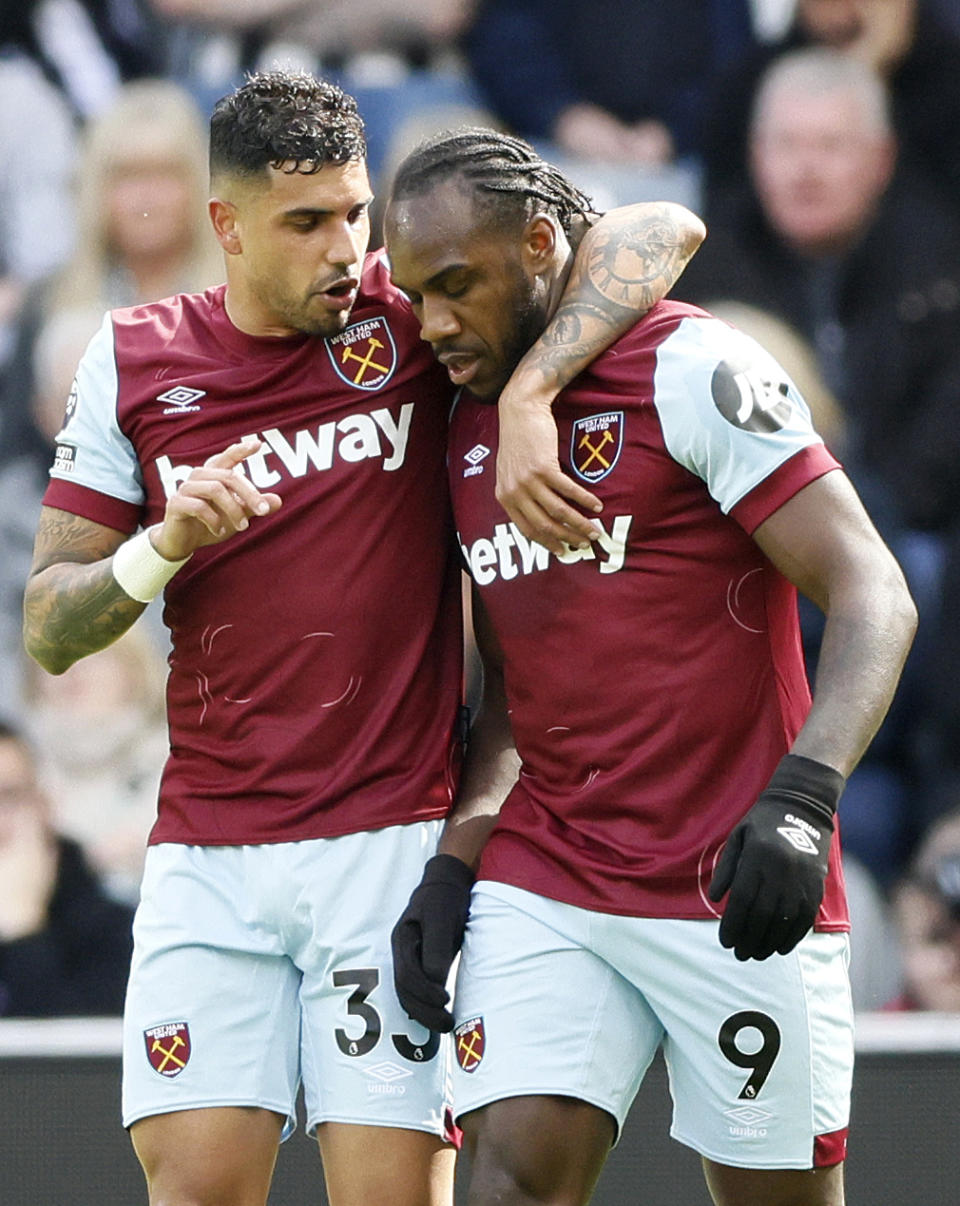 West Ham United's Michail Antonio, right, celebrates with Emerson Palmieri after scoring his side's first goal during the English Premier League soccer match between Newcastle United and West Ham at St. James' Park, Newcastle upon Tyne, England, Saturday March 30, 2024. (Richard Sellers/PA via AP)