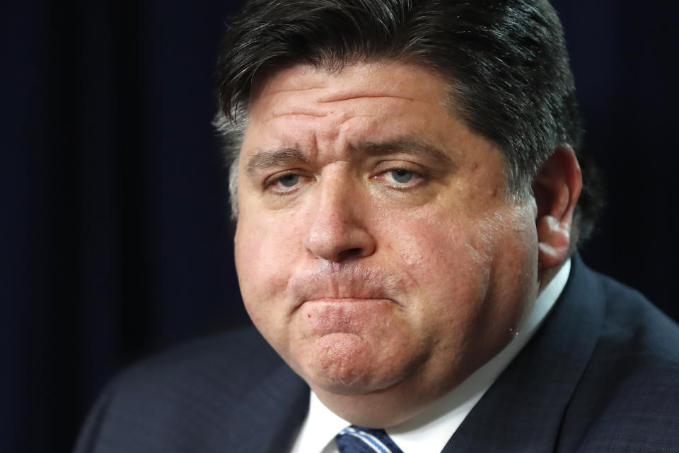 In this March 19, 2020 photo, Illinois Gov. J.B. Pritzker listens to a question during a news conference in Chicago. Amid an unprecedented public health crisis, the nation’s governors are trying to get what they need from the federal government – and fast. But often that means navigating the disorienting politics of dealing with President Donald Trump. (AP Photo/Charles Rex Arbogast)