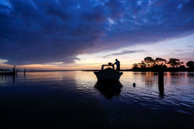 Frankie Crosby of Eastpoint, Florida, U.S., prepares his boat for a day of work harvesting oysters from Apalachicola Bay