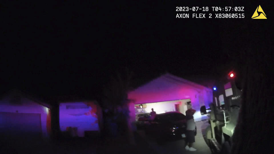 In this Monday evening, July 17, 2023 image taken from police body camera video provided by the Las Vegas Metropolitan Police Department, an unidentified man and woman are seen as SWAT officers raided a home in the nearby city of Henderson, Nevada, in connection with the 1997 killing of rapper Tupac Shakur near the Las Vegas Strip.  / Credit:  AP