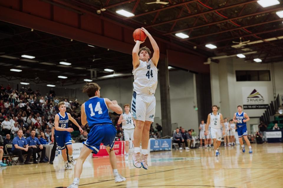 Missoula Loyola's Reynolds Johnston puts up a shot in the Class B state boys' basketball title game on Saturday at Four Seasons Arena.