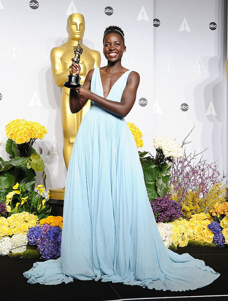 Lupita Nyong'o holding her Oscar