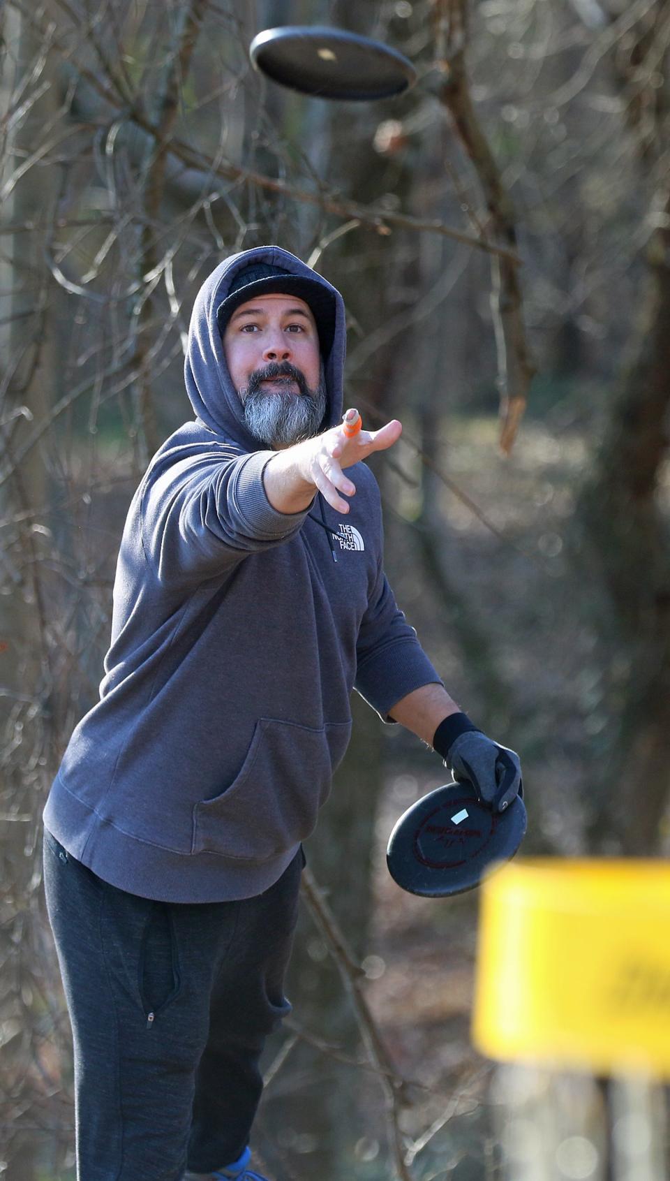 Ben Bivins competes in the first tournament held at Wolfman Disc Golf Club at Wolfman Woods on Artee Road in Lattimore early Saturday morning, Jan. 29, 2022.