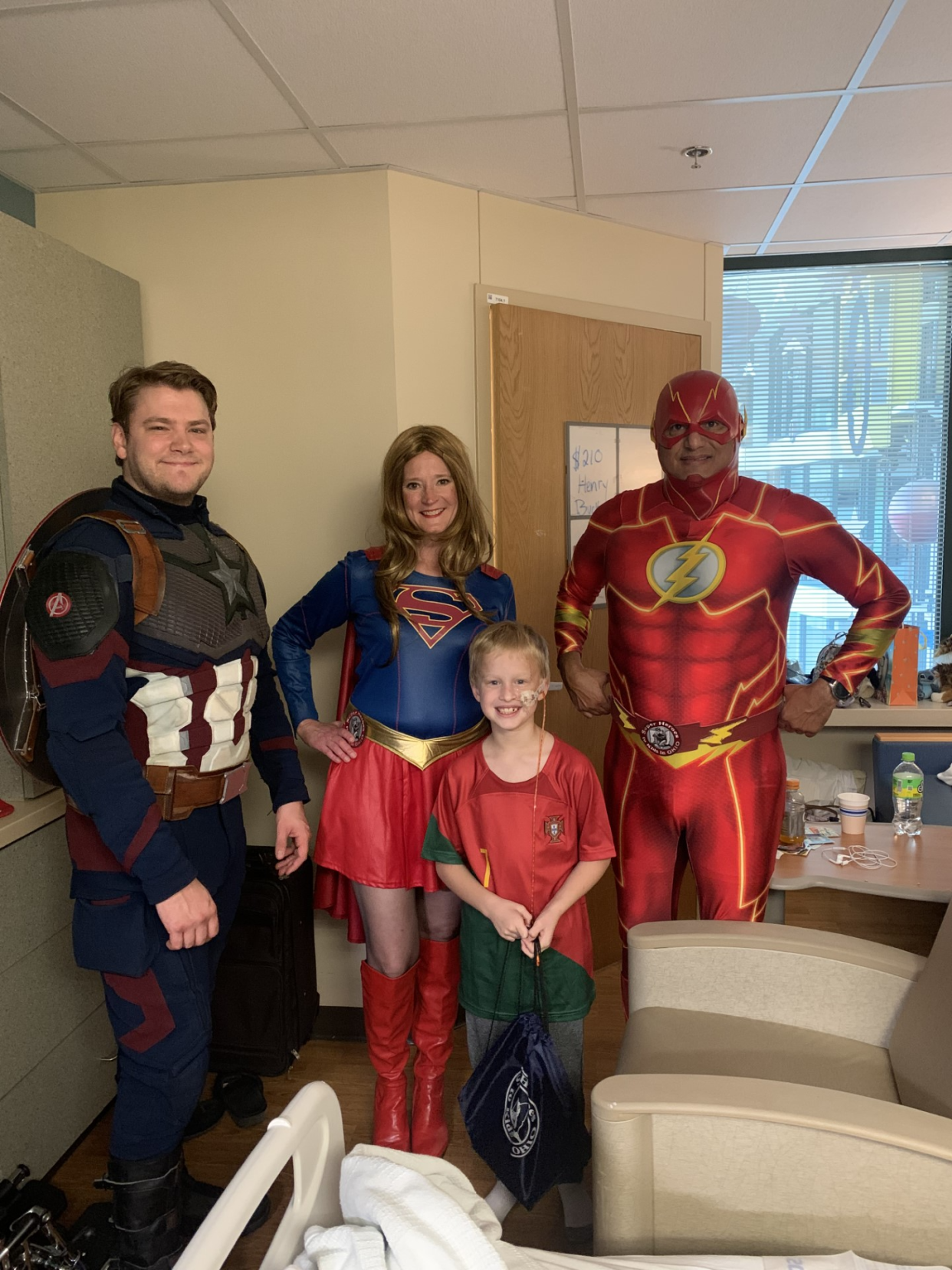 Jordan Owens, who was injured while riding his bike on Labor Day near his Plain Township home, is recovering from his injuries at Akron Children's Hospital. He is shown with volunteers from Super Heroes to Kids in Ohio during their Sept. 30 visit to the hospital. With the 8-year-old are, from left, Joshua Rutherford as Captain America, Michelle Dean as Supergirl and Hector Cirilo as Flash.