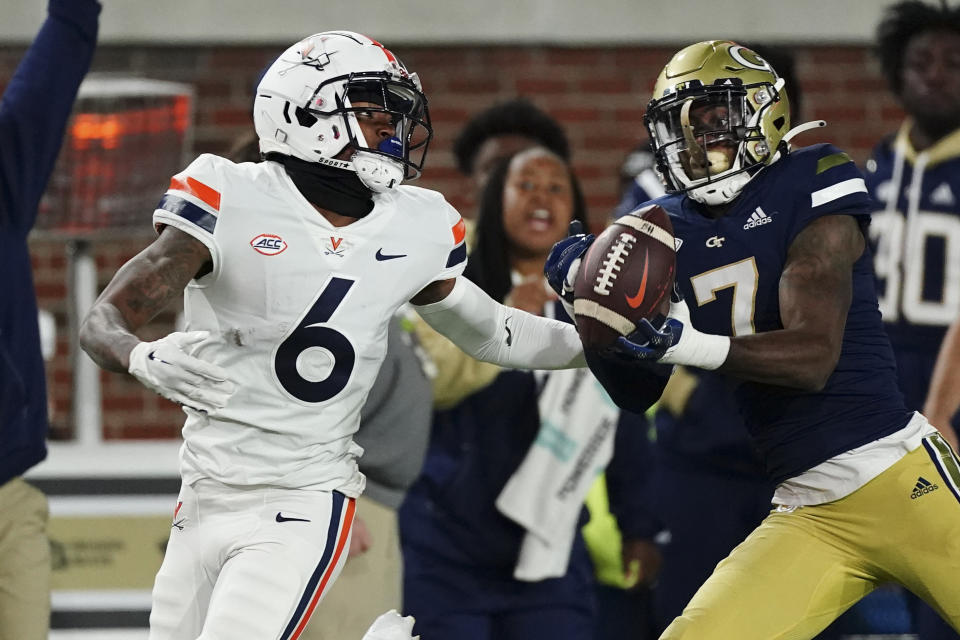 Georgia Tech defensive back Zamari Walton (7) intercepts a pass intended for Virginia running back Demick Starling (6) during the first half of an NCAA college football game Thursday, Oct. 20, 2022, in Atlanta. (AP Photo/John Bazemore)