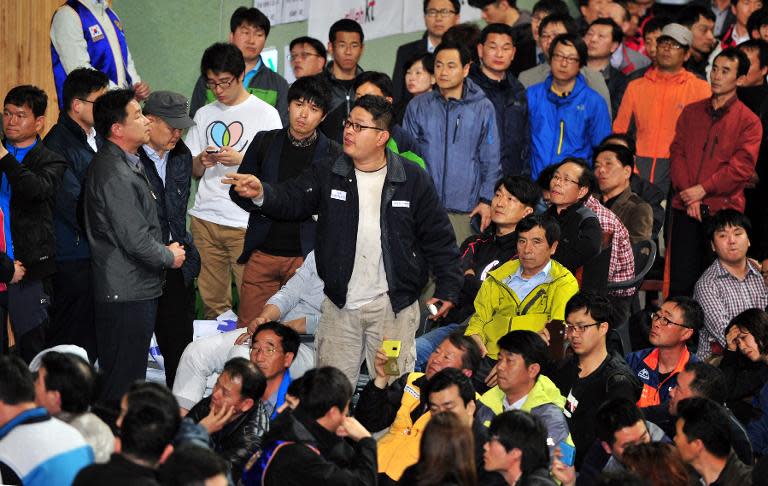 A relative of missing passengers on board a capsized ferry asks questions to South Korean President Park Geun-Hye (not pictured) as she visits Jindo, on April 17, 2014