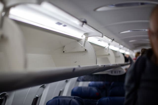 <p>Shelby Knowles/Bloomberg via Getty</p> Empty overhead bin on an airplane