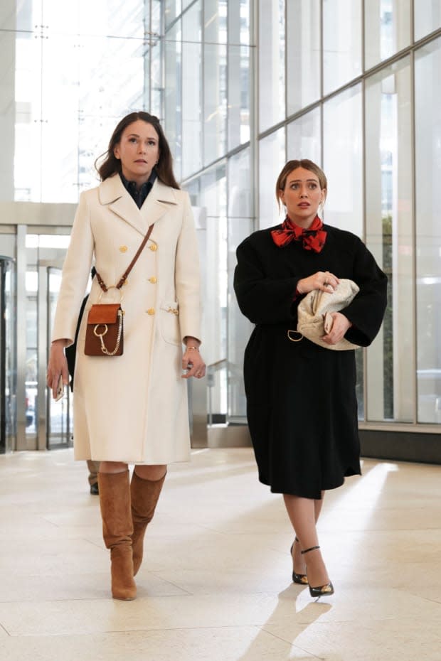 Liza (Sutton Foster) in her repeated white Gucci coat and Chloe Faye mini bag and Kelsey (Hilary Duff) carrying Bottega Veneta.