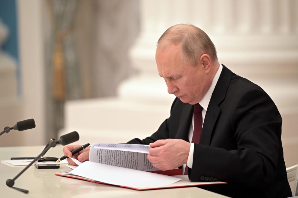 Russia's President Vladimir Putin signs decrees to recognize independence of the Donetsk and Lugansk People's Republics.