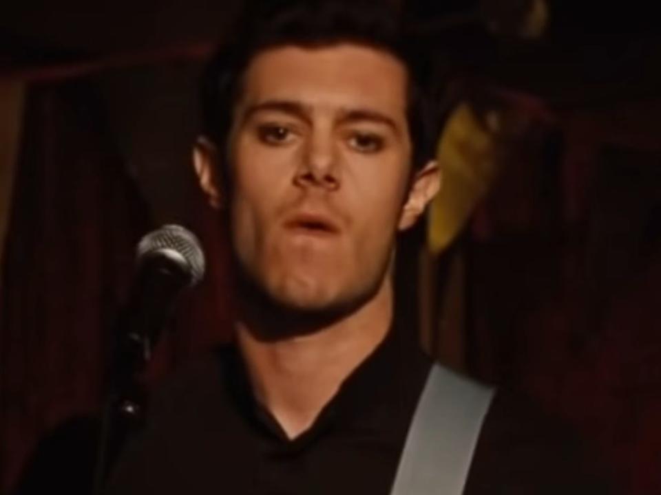 adam brody playing the guitar on stage in jennifer's body