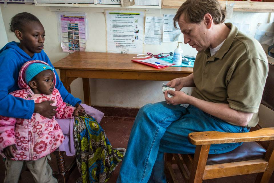 Austin Dr. Jeffrey Kane meets with a mom and her young daughter in Kenya.