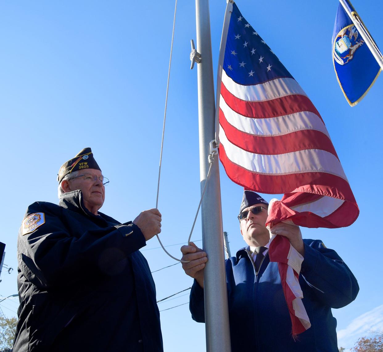 Veterans Terry Rollins and Tom Sancrant of Erie Post 3925, Veterans of Foreign Wars prepare to post the colors in the 2021 Luna Pier Veterans Day service. Several Veterans Day observance are planned in the county this year.