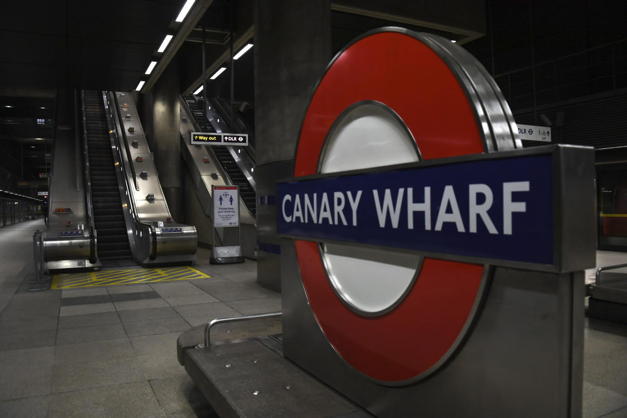 An empty Canary Wharf station at what would normally be the morning rush hour in London, Tuesday, March 24, 2020. Britain's Prime Minister Boris Johnson on Monday imposed its most draconian peacetime restrictions due to the spread of the coronavirus on businesses and gatherings, health workers begged for more gear, saying they felt like "cannon fodder." For most people, the new coronavirus causes only mild or moderate symptoms. For some it can cause more severe illness. (AP Photo/Alberto Pezzali)