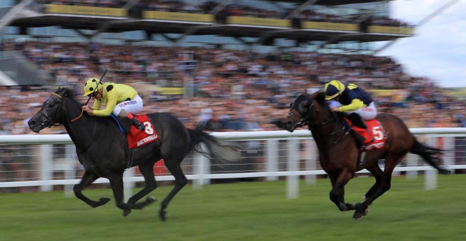 Defoe (left) ridden by Andrea Atzeni on the way to winning the Geoffrey Freer Stakes at Newbury last season