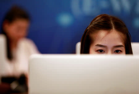 Government staff work as they monitor social media in a social media war room in Bangkok, Thailand March 8, 2019. Picture taken March 8, 2019. REUTERS/Soe Zeya Tun