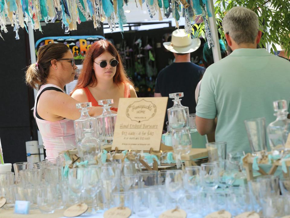 Patrons browse through the booths during the Druid City Arts Festival at Government Plaza Saturday, May 15, 2021. [Pool Photo/Gary Cosby Jr.]