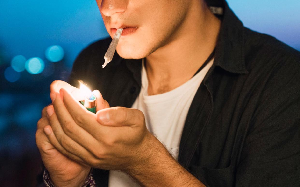 Young man smoking a joint