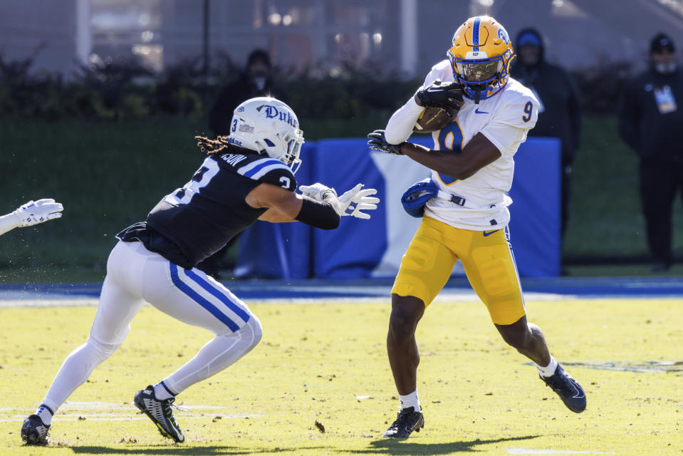 Pittsburgh's Konata Mumpfield (9) carries the ball past Duke's Brandon Johnson (3) during the first half of an NCAA college football game in Durham, N.C., Saturday, Nov. 25, 2023. (AP Photo/Ben McKeown)