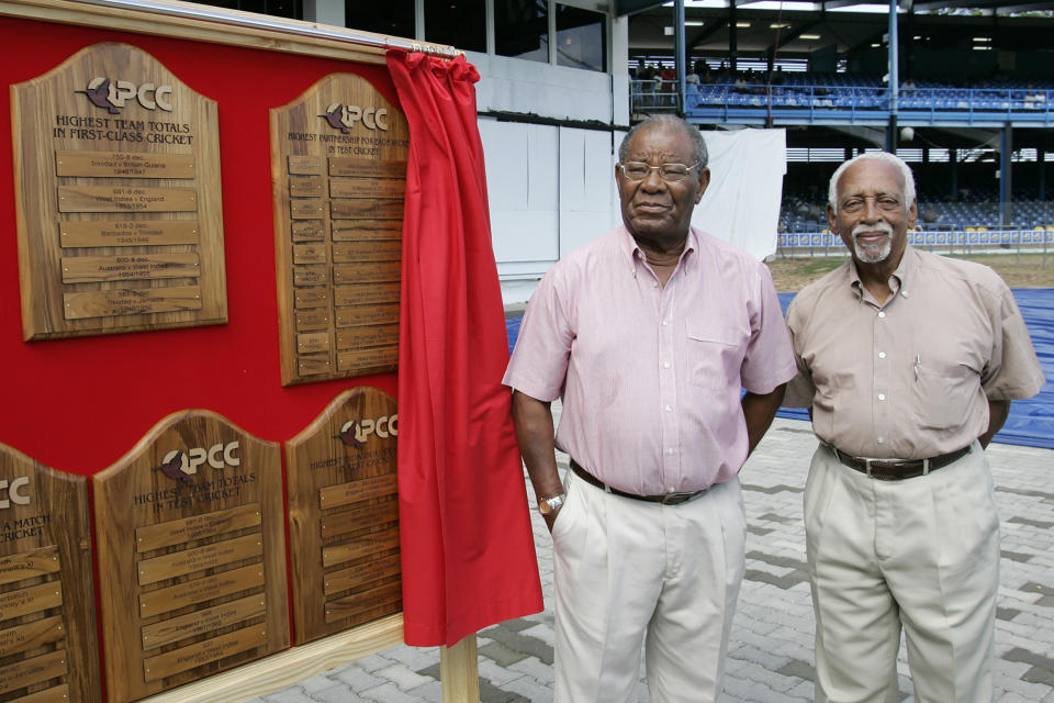 FIEL - In this April 5, 2008, file photo, former West Indies' cricket players Everton Weekes, left, and Andy Gantaume stand in front of a display honoring Frank Worrell during a ceremony before the third day of the second cricket test match between the West Indies and Sri Lanka at the Queen's Park Oval in Port-of-Spain, Trinidad. Weekes, who formed one of the famous three "Ws" of West Indian cricket as part of a formidable batting lineup for more than a decade, has died. He was 95. West Indies Cricket said Weekes died Wednesday, July 1, 2020. (AP Photo/Lynne Sladky, File)