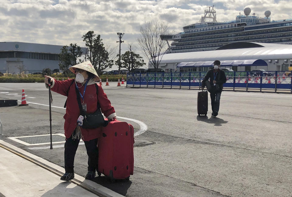 YOKOHAMA, JAPAN - FEBRUARY 19, 2020: Passengers are leaving the Diamond Princess cruise liner, operated by Carnival Corp, after a two-week coronavirus quarantine in the port of Yokohama. The Diamond Princess cruise ship has been quarantined since arriving in Yokohama on February 3, 2020 with more than 3,000 people on board. More than 500 passengers aboard the cruise ship have tested positive for the novel coronavirus since February 4. The outbreak of the 2019-nCoV coronavirus began in Wuhan, China in December 2020. As of 19 February, the number of people in China infected with the new coronavirus has reached more than 74,000, the number of coronavirus cases in Japan has reached 74. Igor Belyayev/TASS (Photo by Igor Belyayev\TASS via Getty Images)