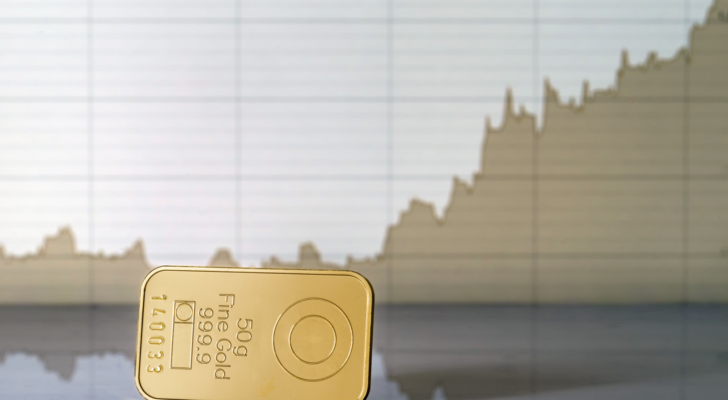 Gold bar on the background of the growth chart. Selective focus.. Gold price predictions