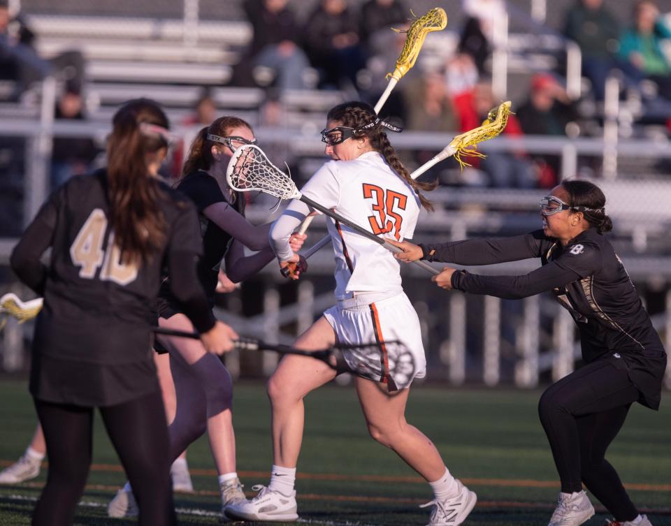 Hoover's Ava Streb brings the ball down field in the first half against a host of Hathaway Brown defenders at Hoover Thursday, April 25, 2024.