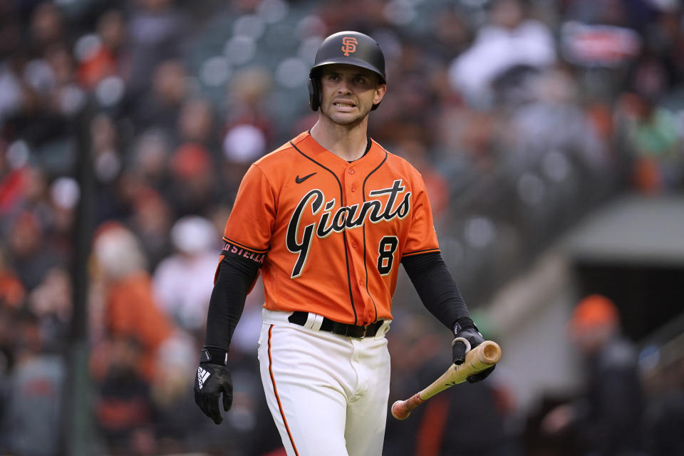 San Francisco Giants' Tommy La Stella walks back to the dugout after striking out with the bases loaded during the first inning of the team's baseball game against the Chicago White Sox in San Francisco, Friday, July 1, 2022. (AP Photo/Eric Risberg)