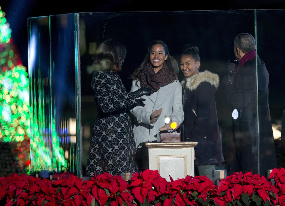 First lady Michelle Obama, Malia Obama, Sasha Obama and President Barack Obama react as they light the 2014 National Christmas Tree during the National Christmas Tree lighting ceremony at the Ellipse near the White House in Washington, Thursday, Dec. 4, 2014.