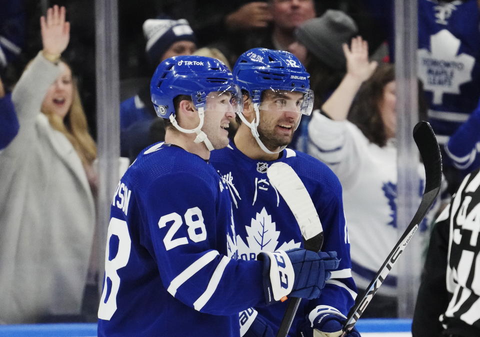 Toronto Maple Leafs' Joey Anderson (28) celebrates his goal against the Anaheim Ducks with Zach Aston-Reese during the third period of an NHL hockey game in Toronto on Tuesday, Dec. 13, 2022. (Frank Gunn/The Canadian Press via AP)