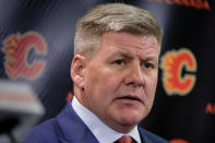 FILE - In this April 23, 2018, file photo, new Calgary Flames NHL hockey team head coach Bill Peters speaks to the media in Calgary, Alberta. Calgary Flames general manager Brad Treliving said the team is looking into an accusation that head coach Bill Peters directed racial slurs toward a Nigerian-born hockey player a decade ago in the minor leagues, then arranged for the player’s demotion when he complained. Akim Aliu tweeted Monday, Nov. 25, 2019, that Peters “dropped the N bomb several times towards me in the dressing room in my rookie year because he didn’t like my choice of music.” (Jeff McIntosh/The Canadian Press via AP, File)